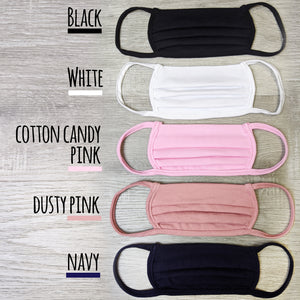 Standard size pleated face masks in black, white, candy pink, dusty pink, and navy.